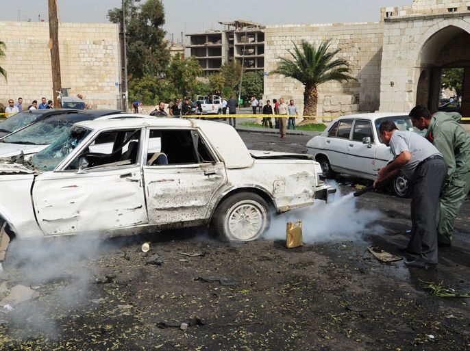 A handout picture released by the Syrian Arab News Agency (SANA) shows Syrians dousing a car following a bomb explosion outside a police station in a Christian quarter of Damascus' Old City on October 21, 2012. Peace envoy Lakhdar Brahimi urged the two sides in Syria's conflict to declare unilateral truces for this week's Muslim holidays after meeting President Bashar al-Assad, even as a deadly bomb rocked Damascus. AFP PHOTO/HO/SANA == RESTRICTED TO EDITORIAL USE - MANDATORY CREDIT "AFP PHOTO / HO / SANA" - NO MARKETING NO ADVERTISING CAMPAIGNS - DISTRIBUTED AS A SERVICE TO CLIENTS ==