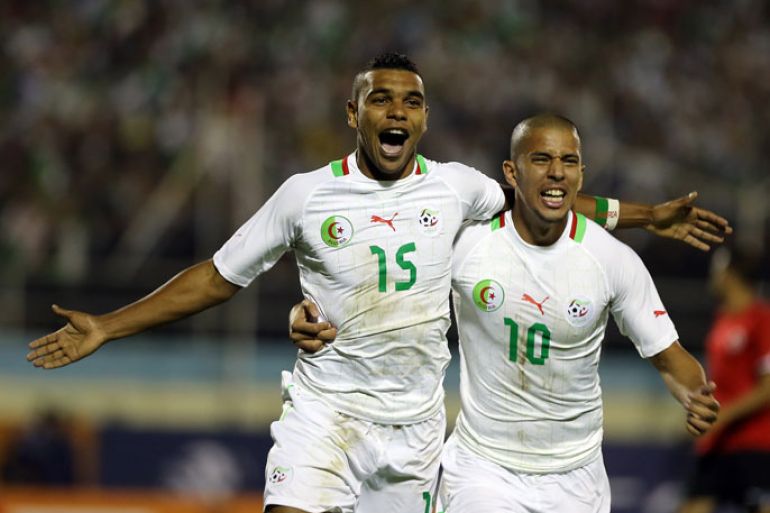 epa03433416 Algerian player El Arabi Hilal Soudani (L) celebrates after scoring against Libya with Sofian Feghouli (R), during the African Cup of Nations 2013 qualifying soccer match at Mustapha Tchaker Stadium in Blida, 50 Km South of Algiers, Algeria, 14 October 2012. EPA/MOHAMED MESSARA