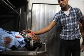 A Palestinain looks at the body of Salafist leader Hisham al-Saedini in al-shifa hospital morgue following an Israeli airstrike in the northern town of Jabaliya, in the Gaza Strip, on October 13, 2012. An Israeli air strike Saturday on the Gaza Strip has killed the coastal enclave's main