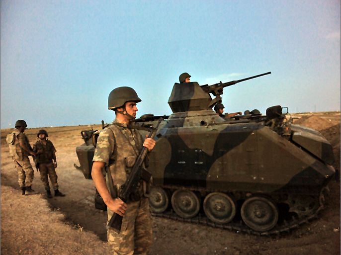 Caption:Turkish soldiers stand guard in Akcakale by the Turkish-Syria border on October 4, 2012 in southern Sanliurfa province. Turkish artillery hit targets near Syria's Tel Abyad border town for a second day today, killing several Syrian soldiers according to activists and security sources, after a mortar bomb fired from the area killed five Turkish civilians. Prime Minister Recep Tayyip Erdogan said that Turkey has no intention of going to war with Syria, hours after parliament authorised possible cross-border attacks.