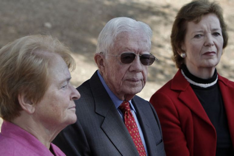 Former US president Jimmy Carter (C), former president of Ireland Mary Robinson (R) and former prime minister of Norway Gro Harlem Brundtland (L) listen to a guide as they tour East Jerusalem, on October 22, 2012, during the second day of a visit by "The Elders", a group of global leaders focused on human rights. AFP PHOTO /AHMAD GHARABLI