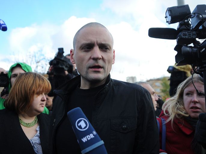 Ultra-left opposition leader Sergei Udaltsov speaks with journalists after being questioned in the Investigative Committee offices in Moscow, on October 26, 2012. Russia charged today Udaltsov with plotting mass riots in a controversial probe that has seen the detention of another activist who claims to have been tortured into confessing. He will remain under travel restrictions that prevent him from leaving Moscow, which were imposed earlier this month when Udaltsov was named as a suspect in the case, Investigative Committee spokesman said. Udaltsov was, however, not placed under arrest. AFP PHOTO / ANDREY SMIRNOV