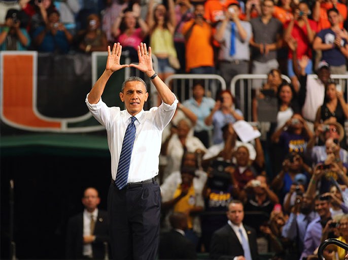 MIAMI, FL - OCTOBER 11: U.S. President Barack Obama puts his hands in the shape of a U, which is the University of Miami symbol, before speaking during a campaign rally at the BankUnited Center at the University of Miami on October 11, 2012 in Miami, Florida. President Obama continues to campaign across the nation with less than a month to go until the election.