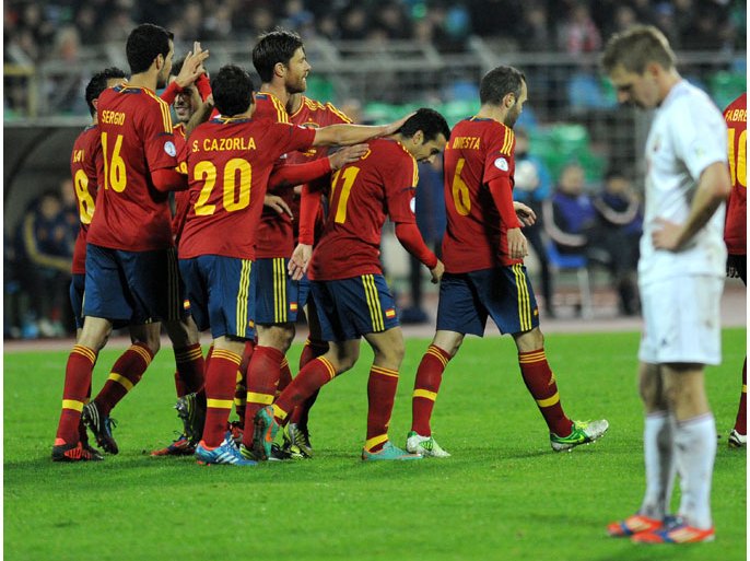 Spain's national football team celebrate during the FIFA 2014 World Cup qualifying match between Belarus and Spain at the Dinamo Stadium in Minsk, on October 12, 2012. AFP PHOTO / VIKTOR DRACHEV