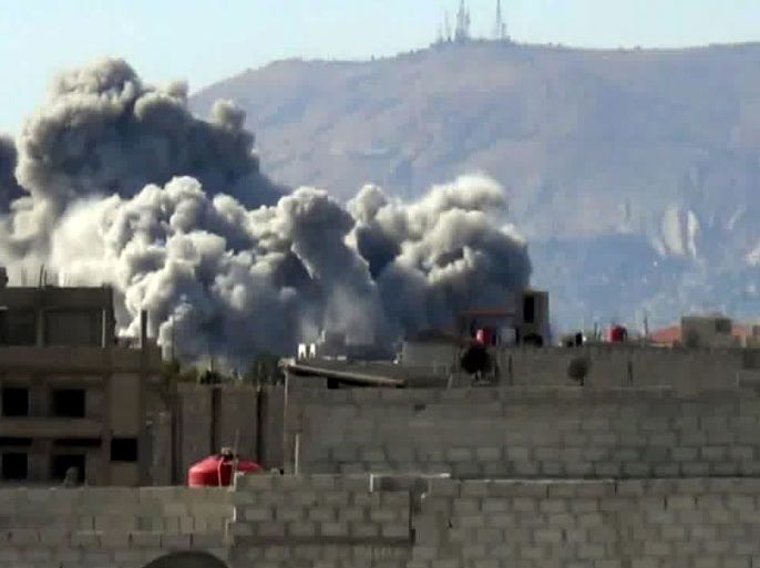 An image grab taken from a video uploaded on YouTube on October 29, 2012, allegedly shows smoke billowing from buildings following shelling by forces loyal to Syrian President Bashar al-Assad on east Ghouta, near the capital Damascus. Clashes erupted between Syrian rebels and troops backed by Palestinian fighters near Damascus on Octboer 30, as the UN-Arab League peace envoy was due in China in a bid to revive struggling efforts to halt the violence. AFP PHOTO/YOUTUBE ==