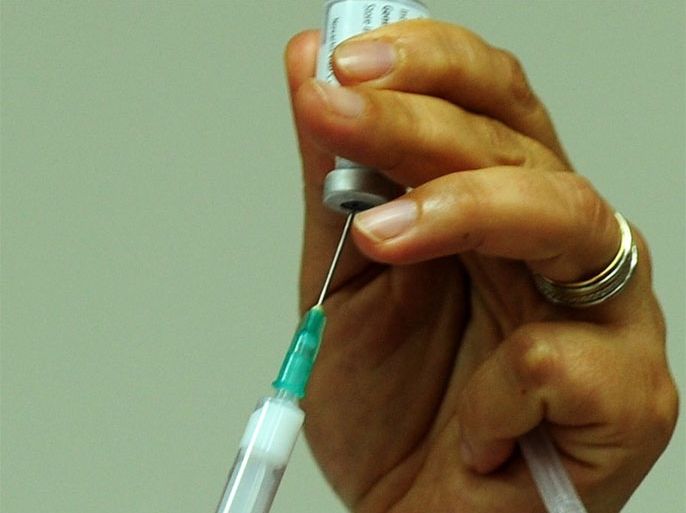 A nurse prepares a shot of the A(H1N1) vaccine (Pandemrix from Glaxo Smith Kline -GSK- laboratory) to a hospital staff member in Istanbul, on November 2, 2009. Turkey began vaccinating medical workers Monday as the death toll from the A(H1N1) virus in the country reached six, the health ministry said. The latest victims of the disease were a 22-month-old baby and a 14-year-old boy who died overnight in the central city of Konya, a ministry statement said. Nine other people infected with swine flu were in serious condition in intensive care at the country's medical facilities, it added.