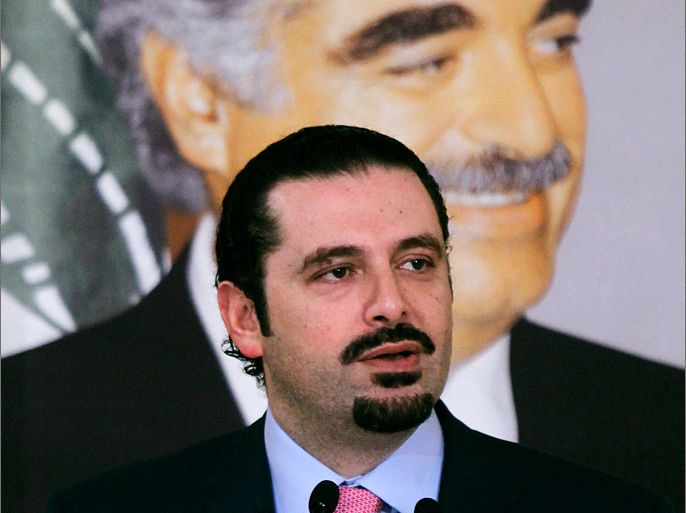 Lebanon's outgoing Prime Minister Saad al-Hariri speaks during a news conference at his residence in Beirut in this February 28, 2011 file photo. In the background is a picture of his father, former Prime Minister Rafik al-Hariri. Saad al-Hariri accused Syrian President Bashar al-Assad on October 19, 2012 of being behind the huge car bomb which killed a senior Lebanese intelligence official in central Beirut. REUTERS/Mohamed Azakir/Files (LEBANON - Tags: POLITICS)