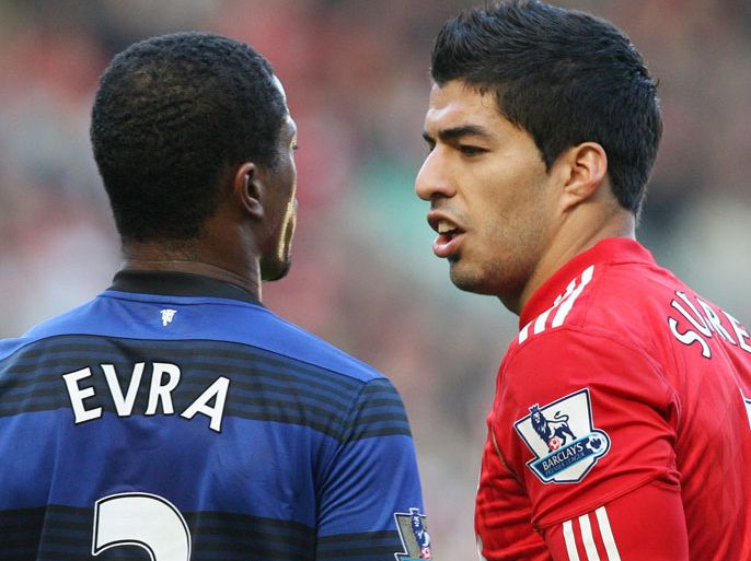 epa02968710 Liverpool's Luis Suarez (R) and Manchester United captain Patrice Evra during an altercation in their English Premier League soccer match at Anfield, in Liverpool, Britain, 15 October 2011. Reports on 16 October state that Evra has filed a complaint to the English Football Association, alleging Suarez racially abused him during the match. EPA/LINDSEY PARNABY DataCo Terms & Conditions apply:
