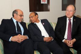 Tunisian President Moncef Marzouki (C) talks with Prime Minister Hamadi Jebali (L) in the presence of Constituent Assembly President Mustapha Ben Jaafer (R) during a meeting to negotiate a consensus on the content and timing of the adoption of the Constitution on October 16, 2012 in Tunis. The meeting, called by Tunisia's main trade union, the UGTT, gathered more than 40 political groups in a bid to resolve the impasse over drafting the text by the National Constituent Assembly, but was boycotted by two key parties. AFP PHOTO / FETHI BELAID