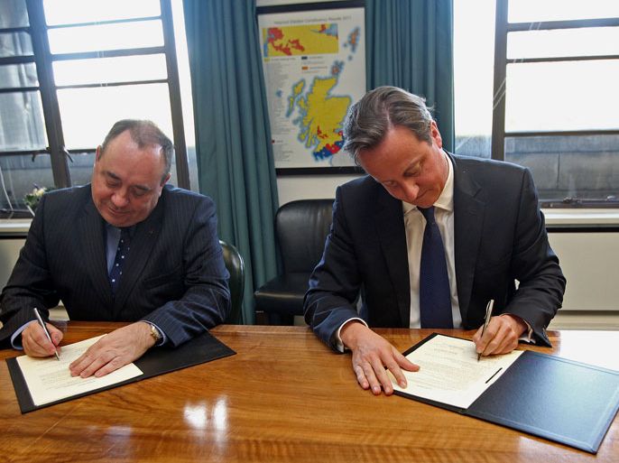 Scotland's First Minister Alex Salmond (L) and British Prime Minister David Cameron sign an agreement to hold a referendum on Scottish independence at St Andrew's House in Edinburgh, Scotland, on October 15, 2012. Cameron strongly opposes a Scottish breakaway and the signing of the terms for the vote fires the starting gun on two years of campaigning which puts the leaders firmly in opposing camps. AFP
