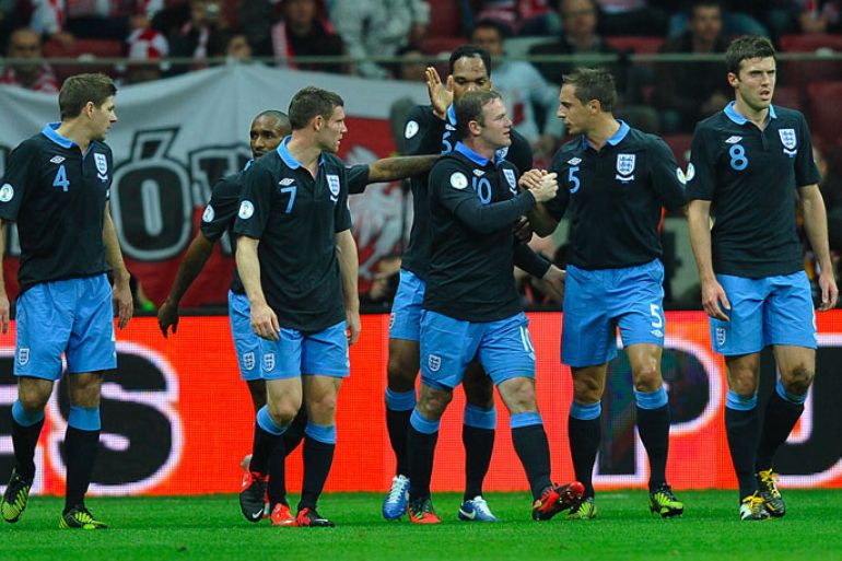 England's forward Wayne Rooney (3rd R) celebrates scoring with his teammates during the FIFA 2014 World Cup qualifying football match Poland vs England in Warsaw on October 17, 2012. AFP PHOTO / PIOTR HAWALEJ
