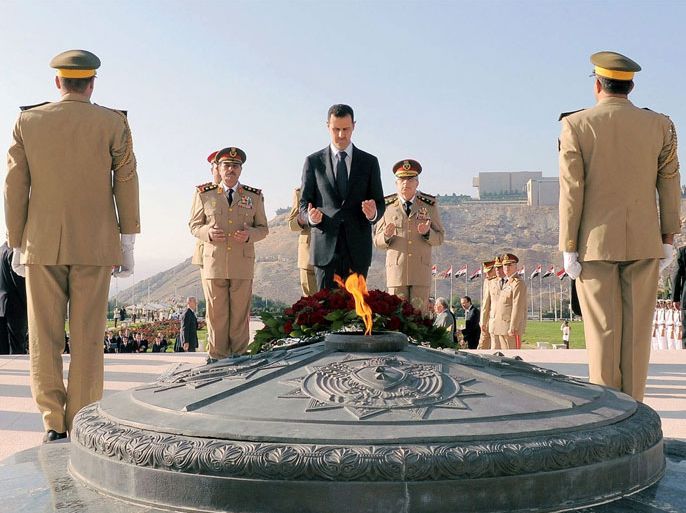 A handout photo made available by the official Syrian Arab News Agency (SANA) shows Syrian President Bashar Assad (C) visiting the tomb of the Unknown Soldier in Damascus, Syria, 06 October 2012. Syria commemorates the 39th anniversary of the 1973 Arab-Israeli war, known as the October war, when Egypt and Syria took advantage of the Jewish Yom Kippur holiday to launch surprise attacks on territory occupied by Israel in previous conflicts.