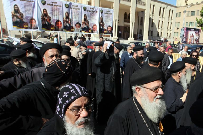 epa03451177 Egyptian Coptic priests stand in a line wiating to cast their votes in the election of a new pope, at the Saint Mark's Coptic Cathedral in in Cairo, Egypt, 29 October 2012. Egypt's Coptic Christians vote on 29 October for a new pope to succeed Pope Shenouda III, who led the Coptic Orthodox Church from more than 40 years until his death in March.