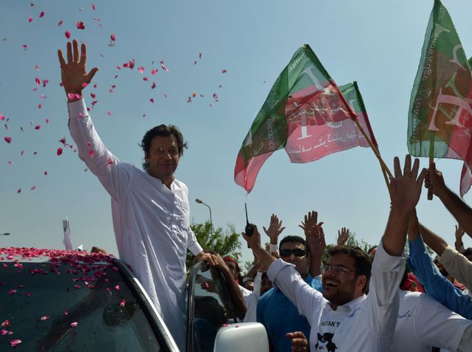 Pakistan cricketer turned politician Imran Khan waves to supporters at the start of a rally on the outskirts of Islamabad on October 6, 2012. Khan is leading western peace activists and local loyalists on a highly publicised rally to Pakistan's tribal belt in protest against US drone strikes. AFP PHOTO/A MAJEED