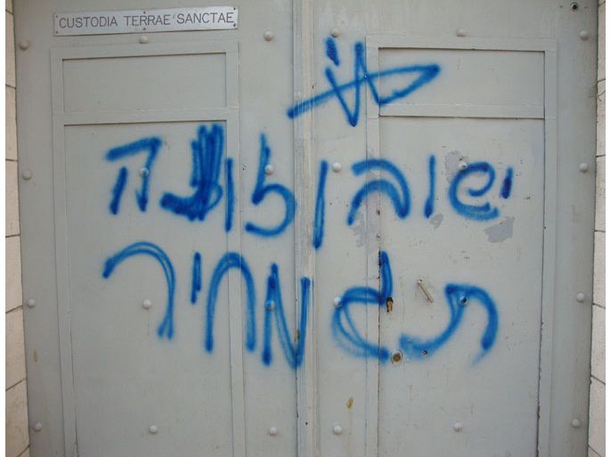 A handout picture released by the Franciscan monastery on October 2, 2012, shows anti-Christian graffiti denigrating Jesus, the central figure in Christianity, and adding the words "price tag" -- a euphemism for revenge hate crimes by Israeli extremists, sprayed in Hebrew on the front entrance to Franciscan monastery just outside Jerusalem's Old City, the church and Israeli police said in an apparent "price-tag" hate crime. . AFP PHOTO/HO == RESTRICTED TO EDITORIAL USE - MANDATORY CREDIT "AFP PHOTO / HO" - NO MARKETING NO ADVERTISING CAMPAIGNS - DISTRIBUTED AS A SERVICE TO CLIENTS