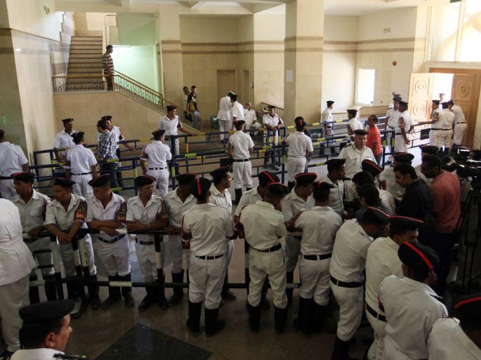 Egyptian policemen and journalist are seen in the hall of the court house where the so called 'Camel battle' trial resuming, in Cairo, Egypt, 11 June 2012. The trial of 25 former officials and politicians charged with masterminding an attack on anti-government demonstrators using horse and camel riders in Egypt will continue under a media ban. The defendants are accused of commissioning gangs of horse and camel riders to attack and kill protesters camped out in Cairo's Tahrir Square in February 2011 during demonstrations against then president Hosni Mubarak