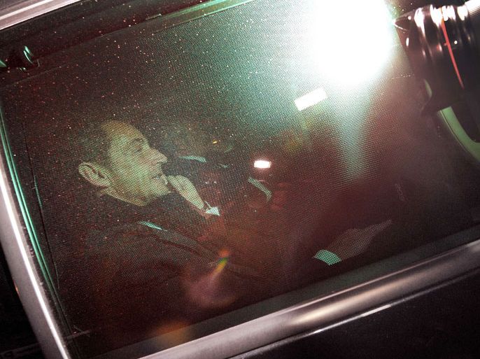 Former French president Nicolas Sarkozy (L) leaves the Bordeaux' courthouse in a car on November 22, 2012 at the end of a twelve-hour-long interrogation by the investigating judges, to respond to charges that his 2007 electoral campaign was financed with funds secured illegally from France's richest woman, Liliane Bettencourt. Sarkozy avoided indictment in illegal campaign financing case, according to his lawyer. Instead, lawyers for the 57-year-old said, prosecutors will continue to deal with Sarkozy as a witness under caution