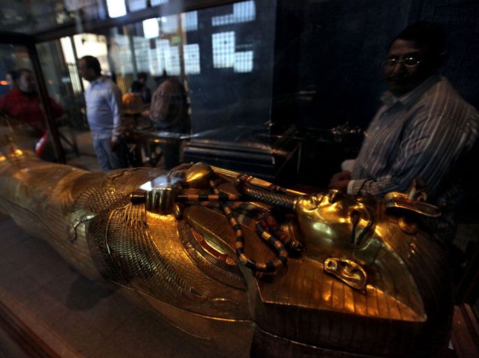 A man stands by the coffin of Tutankhamun on display at the Egyptian Museum in Cairo, Egypt, 21 February 2011, one day after the archaeological sites in Egypt were reopend to the public. The archaeological sites had been closed due to security measures since the nation-wide protests that toppled President Hosny Mubarak. EPA/KHALED ELFIQI