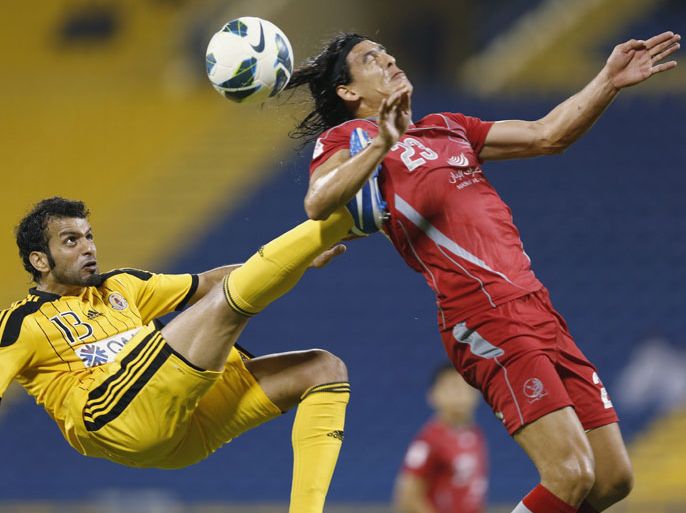 Lekhwiya's Sebastian Soria (R) fights for the ball with Qatar's S.C. Khaled Saleh during the Qatar Stars League in Doha, November 18, 2012. REUTERS/Fadi Al-Assaad (QATAR - Tags: SPORT SOCCER TPX IMAGES OF THE DAY)