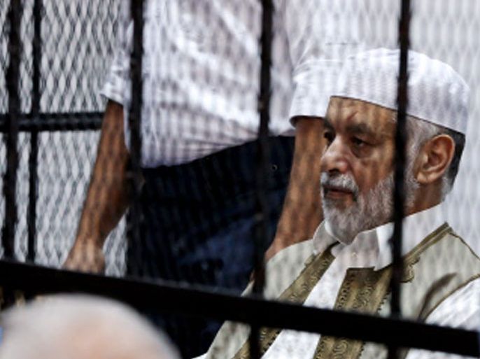 Former Libyan prime minister Baghdadi al-Mahmudi sits behind bars during the first hearing in his trial at a courtroom in Tripoli on November 12, 2012. The trial of Mahmudi, late Libyan dictator Moamer Kadhafi's last prime minister, opened in the Libyan capital as he faces charges of "prejudicial acts against the security of state". AFP PHOTO/MAHMUD TURKIA
