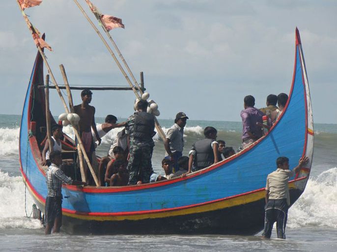 Rohingya refugees, who survived after their overloaded boat heading to Malaysia sank, are pictured on a fishing boat following their rescue by Bangladeshi border guards in Teknaf on November 7, 2012. About 85 people are missing after an overloaded boat carrying Rohingya refugees towards Malaysia sank off Bangladesh early on November 7, the second such tragedy in less than a fortnight, officials said. AFP PHOTO/STR