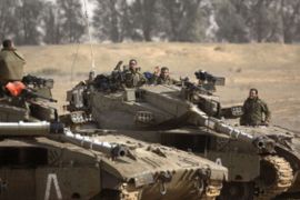 Israeli tanks maneuver at the Israeli-Gaza Strip border on November 16, 2012. Israeli officials said the Jewish state was preparing to launch its first ground offensive in four years into the Gaza Strip and the army started calling up 16,000 reservists. AFP PHOTO/MENAHEM KAHANA