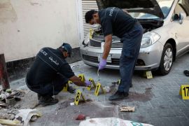 Manama, -, BAHRAIN : Bahraini police inspect the site of an explosion in the capital Manama on November 5, 2012, following a series of explosions which killed two Asian expatriates and wounded a third, according to a police statement which described the blasts as "acts of terror.