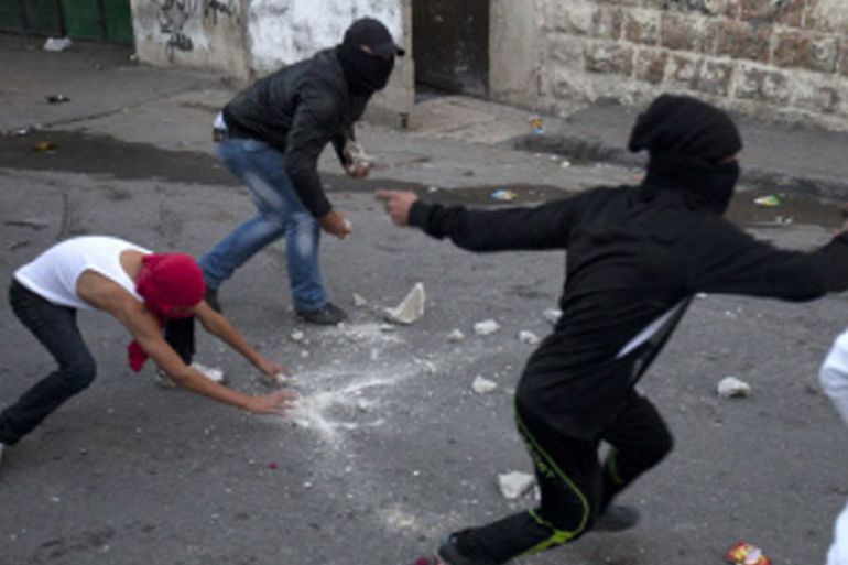JER011 - JERUSALEM, -, - : Masked Palestinian youths hold stones as they clash with Israeli security forces in the Arab Jerusalem neighbourhood of Issawiya on November 15, 2012. The United States blamed Hamas for an explosion of violence in Gaza after salvoes of rockets were fired into Israel in retaliation for the killing of the group's military chief. AFP PHOTO/AHMAD GHARABLI