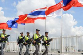 Cambodian security officials walk in formation in front of hoisted flags of the Asian Nations at the Phnom Penh International Airport on November 17, 2012 ahead of an annual Association of Southeast Asian Nations (ASEAN) leaders' summit. US President Barack Obama, on his first overseas trip since his re-election, will arrive in the Cambodian capital from Myanmar on November 19 for the 18-nation East Asia Summit that observers expect will be dominated by a raft of territorial rows