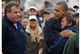 U.S. President Barack Obama hugs North Point Marina owner Donna Vanzant as he tours damage done by Hurricane Sandy in Brigantine, New Jersey, October 31, 2012. At left is New Jersey Governor Chris Christie. Putting aside partisan differences, Obama and Christie toured storm-stricken parts of New Jersey together on Wednesday, taking in scenes of flooded roads and burning homes in the aftermath of superstorm Sandy