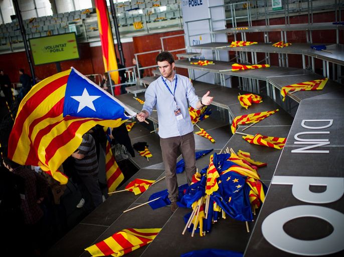 BARCELONA, SPAIN - NOVEMBER 18: A member of the Youth Convergencia i Unio Associations flies a Catalonia Pro-Independence flag prior to the main Convergencia i Unio campaing meeting at the Mar Bella Sports Complex on November 18, 2012 in Barcelona, Spain. Catalonia will hold Parliamentary elections next Novevember 25. President of Catalonia, Artur Mas, wants to call a self-determination referendum in the next 4 for year.