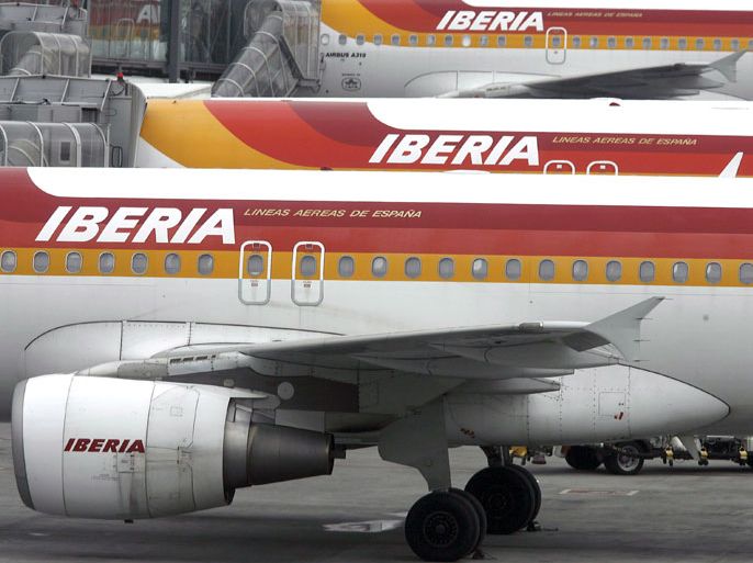 epa03464487 (FILE) Undated file photograph of planes of Spain's national airline Iberia on the tarmac at Barajas Airport in Madrid. Iberia is to cut 4,500 jobs over the next three years as part of a restructuring plan by Spain's biggest airline following its merger with British Airways, joint owner International Airlines Group (IAG) said 09 November 2012. The proposed cuts amount to a reduction of nearly 25 per cent of Iberia's current workforce. The airline will also dispose of a quarter of its fleet and reduce its network capacity by 15 per cent, said IAG. IAG said the restructuring is aimed at safeguarding 15,500 posts at the Spanish airline.