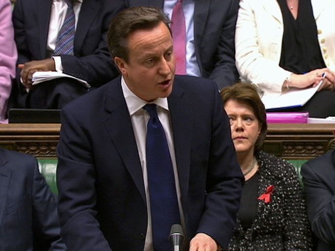 Britain's Prime Minister David Cameron, flanked by Deputy Prime Minister Nick Clegg (L), Culture Secretary Maria Miller (2ndR) and Business Secretary Vince Cable (R), speaks about Lord Justice Brian Leveson's report on media practices in Parliament in this still image taken from video in London November 29, 2012. Cameron rejected the idea of a law to regulate the British