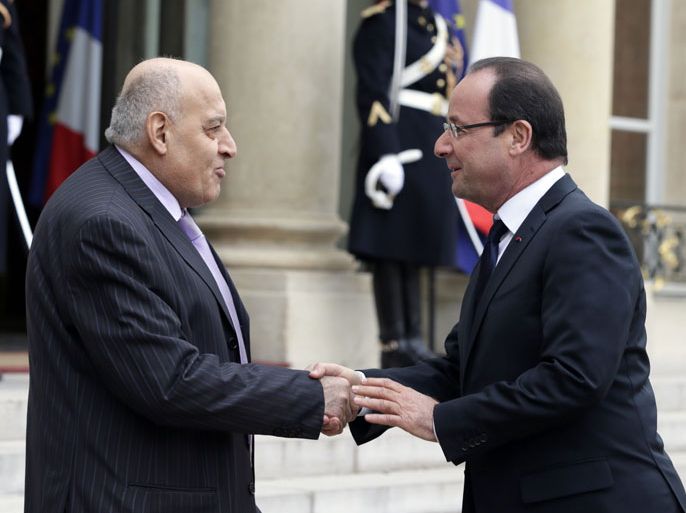 Paris, Paris, FRANCE : French President Francois Hollande (R) shakes hands with Syrian opposition coallition's Ambassador Monzer Makhous (L) at the Elysee Palace in Paris, on November 17, 2012. AFP PHOTO/KENZO TRIBOUILLARD