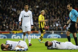 Real Madrid's Portuguese defender Pepe (L) and Real Madrid's defender Sergio Ramos lie on the ground after being injured during the UEFA Champions League football match Real Madrid FC vs Borussia Dortmund at the Santiago Bernabeu stadium in Madrid on November 6, 2012. AFP PHOTO / PIERRE-PHILIPPE MARCOU