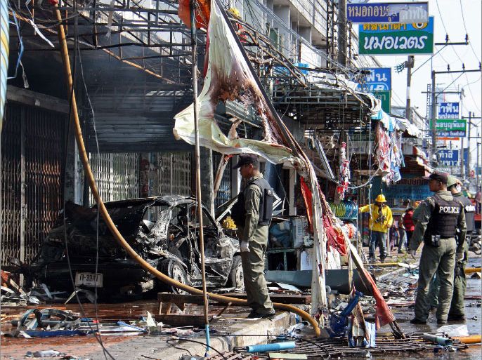 Thai bomb squad officers inspect the site of a bomb blast in Thailand's restive southern province of Yala on November 17, 2012 after a powerful car bomb ripped through a town centre in Thailand's troubled Muslim-majority south, killing at least one and wounding 20, police said. A complex insurgency, without clearly stated aims, has plagued Thailand's far south near the border with Malaysia since 2004, claiming thousands of lives, both Buddhist and Muslim, with near-daily bomb or gun attacks. AFP PHOTO/MUHAMMAD SABRI