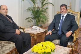 A handout picture released by the Egyptian presidency on November 22, 2012, shows Egyptian President Mohamed Morsi (R) meeting with the newly appointed Prosecutor General Talaat Ibrahim Abdallah at the presidential palace in Cairo. Morsi assumed sweeping powers prompting prominent opposition figure Mohamed ElBaradei to accuse him of usurping authority and becoming a "new pharoah". AFP PHOTO/HO/EGYPTIAN PRESIDENCY == RESTRICTED TO EDITORIAL USE - MANDATORY CREDIT "AFP PHOTO / HO / EGYPTIAN PRESIDENCY" - NO MARKETING NO ADVERTISING CAMPAIGNS - DISTRIBUTED AS A SERVICE TO CLIENTS ==