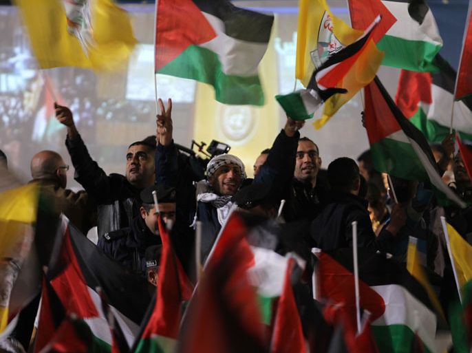 : Palestinians celebrate in the West Bank city of Ramallah on November 29, 2012 after the General Assembly voted to recognise Palestine as a non-member state. The UN General Assembly on Thursday voted overwhelmingly to recognize Palestine as a non-member state, giving a major diplomatic triumph to president Mahmud Abbas despite fierce opposition from the United States and Israel. AFP PHOTO / ABBAS MOMANI
