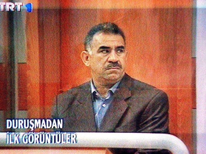 An image taken off TV screen from Turkish TRT TV station showing Abdullah Ocalan, leader of the rebel Kurdistan Workers Party PKK, sitting in a bullet-proof glas case during his trial at the military prison at Imrali island off Turkish coast, Monday, 31 May 1999. A Turkish State Security Court trying Ocalan today rejected a request by defence attorneys to adjourn the trial, the Anatolia news agency said. Ocalan went on trial today