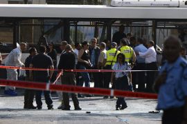 Tel Aviv, -, ISRAEL : Israeli police seal off the area surrounding the bus which was hit by a bomb near the defence ministry in Tel Aviv on November 21, 2012. At least 10 people were injured in an explosion on a bus, Israel's emergency services said, in what an official said was "a terrorist attack." AFP PHOTO / JONATHAN NACKSTRAND