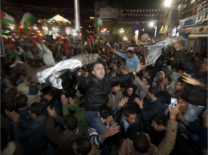 Palestinians celebrate in the West Bank city of Ramallah on November 29, 2012 after the General Assembly voted to recognise Palestine as a non-member state. The UN General Assembly on Thursday voted overwhelmingly to recognize Palestine as a non-member state, giving a major diplomatic triumph to president Mahmud Abbas despite fierce opposition from the United States and Israel. AFP PHOTO/AHMAD GHARABLI