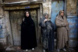 Iranian Shiite Muslim women with mud on their veils watch the 'Kharrah Mali' (Mud Rubbing) ritual to mark the Ashura religious ceremony in the city of Khorramabad, some 470 kms southwest of Tehran on November 25, 2012. "Khrreh Mali" or "Mud Rubbing" is a ritual that is held in the city of Khorramabad every year to commemorate the seventh century slaying