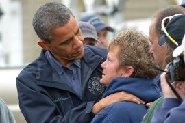 US President Barack Obama comforts Hurricane Sandy victim Dana Vanzant as he visits a neighborhood in Brigantine, New Jersey, on October 31, 2012. Americans sifted through the wreckage of superstorm Sandy on Wednesday as millions remained without power. The storm carved a trail of devastation across New York City and New Jersey, killing dozens of people in several states, swamping miles of coastline, and throwing the tied-up White House race into disarray just days before the vote.