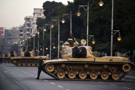 Egyptian army tanks are deployed outside the presidential palace in Cairo on December 13, 2012. Egypt's crisis showed no sign of easing as the army delayed unity talks meant to ease political divisions and the opposition set near-impossible demands for taking part in a looming constitutional referendum
