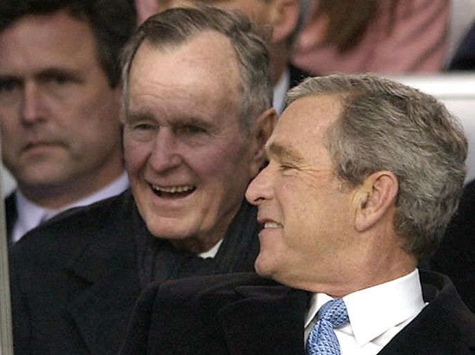 ECH36 - Washington, District of Columbia, UNITED STATES : (FILES): This January 20, 2005 file photo shows then US President George W. Bush (R) speaking with his father, former US President George H.W. Bush