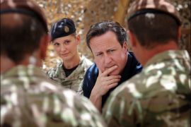 (FILES) In this photograph taken on July 18, 2012, British Prime Minister David Cameron meets British soldiers based at Lashkar Gah in Helmand Province. Britain will withdraw 3,800 of its 9,000 troops from Afghanistan by the end of 2013, Prime Minister David Cameron said on December 19, 2012. AFP PHOTO/POOL/STEFAN ROUSSEAU/FILES