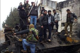 Free Syrian Army fighters from Al-Farooq battalion celebrate atop damaged tanks after the fighters said they fought and defeated government troops in Halfaya, near Hama December 18, 2012. REUTERS/Samer Al-Hamwi/Shaam News Network/Handout (SYRIA - Tags: CONFLICT) FOR EDITORIAL USE ONLY. NOT FOR SALE FOR MARKETING OR ADVERTISING CAMPAIGNS. THIS IMAGE HAS BEEN SUPPLIED BY A THIRD PARTY. IT IS DISTRIBUTED, EXACTLY AS RECEIVED BY REUTERS, AS A SERVICE TO CLIENTS