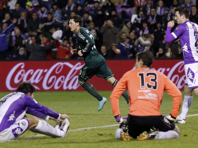 Real Madrid's German midfielder Mesut Ozil (Background) celebrates after scoring during the Spanish league football match Real Valladolid CF vs Real Madrid CF at Jose Zorilla stadium in Valladolid on December 8, 2012. Real Madrid won 3-2. AFP PHOTO/ CESAR MANSO