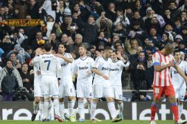 Real Madrid's players celebrate after their teammate German midfielder Mesut Ozil scored during the Spanish league football match Real Madrid CF vs Atletico Madrid at the Santiago Bernabeu stadium in Madrid on December 1, 2012. AFP PHOTO / PIERRE-PHILIPPE MARCOU