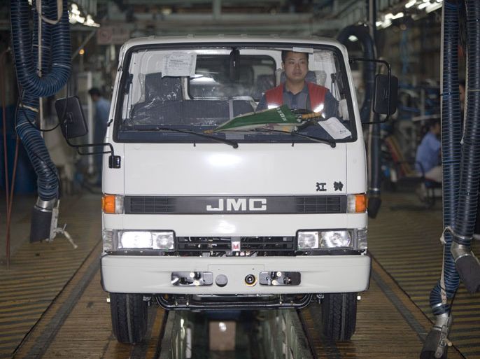 epa01037883 Workers drive off newly finished mini trucks based on Japanese Isuzu truck technology at a production line of the Jiangling Motor Corporation in Nanchang in the southern China province Jiangxi 13 June 2007. Jiangling is a major provincial player in the booming Chinese auto industry with joint ventures producing trucks and commercial vehicles with Japan's Isuzu and Transit minibuses and commercial vehicles with US auto giant Ford. The group also produces a sports utility vehicle under the Landwind brand name which they hope to join their drive for the export market. EPA/ADRIAN BRADSHAW